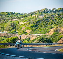 Biker on a classic motorcycle on a winding road