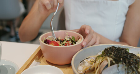 Woman eat salad in restaurant