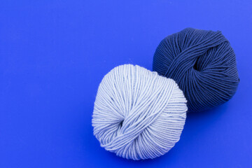 woolen merinos blue threads on blue background. natural wool. knitting. background