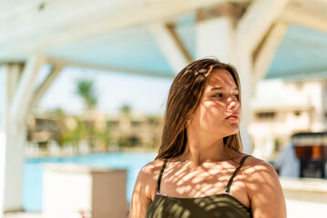 Cheerful plus size teenage girl enjoying near the pool. smiling, happy, positive emotion, summer...