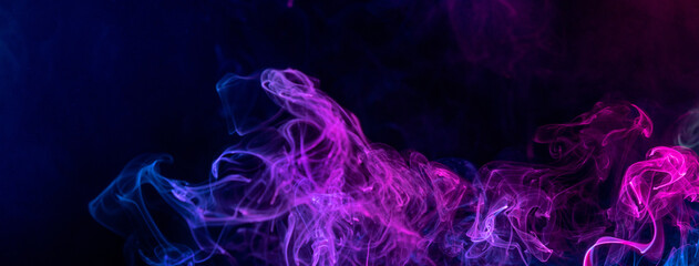 Conceptual image of colorful red and blue color smoke on dark black background.