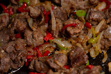 The meat is fried with onions and spices