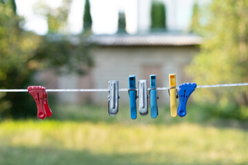 Clothespins hanging on a rope in the street