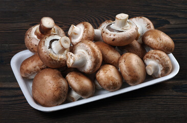 fresh mushrooms champignons on a wooden table
