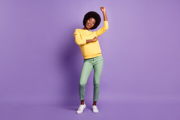 Full length photo of pretty girl closed eyes raise arms wear yellow sweater isolated violet color...