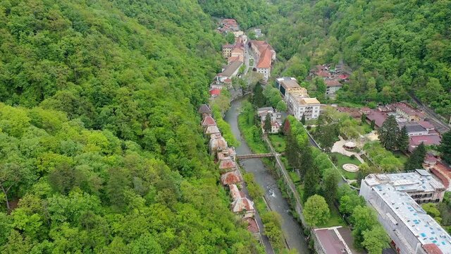 4K Aerial drone view of Baile Herculane - Thermal resort in Romania, gorgeous Austro-Hungarian Imperial Baths between the mountains