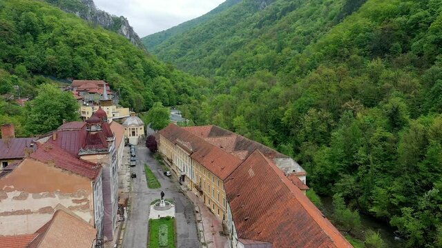 4K Aerial drone view of Baile Herculane - Thermal resort in Romania, gorgeous Austro-Hungarian Imperial Baths between the mountains