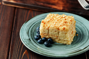 Piece of cake Napoleon on green plate