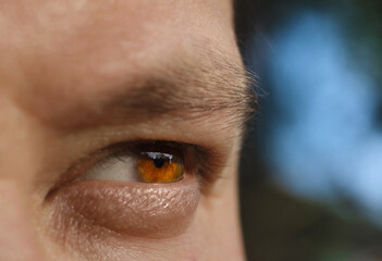 Close-up of the human eye.  The look is thoughtful. The concept of a difficult and important choice.