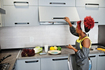 African american woman at home kitchen opens the drawer.