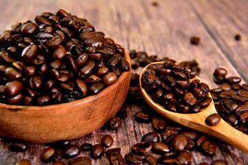 Coffee beans in a wooden bowl with a wooden spoon