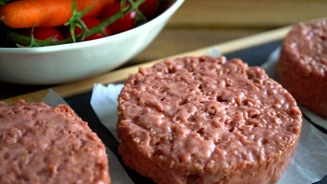 Vegan burger or plant based hamburger raw patty panning in slow motion
