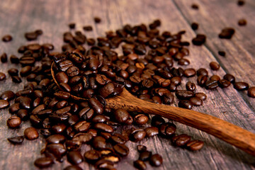 Coffee beans on the table with a wooden spoon