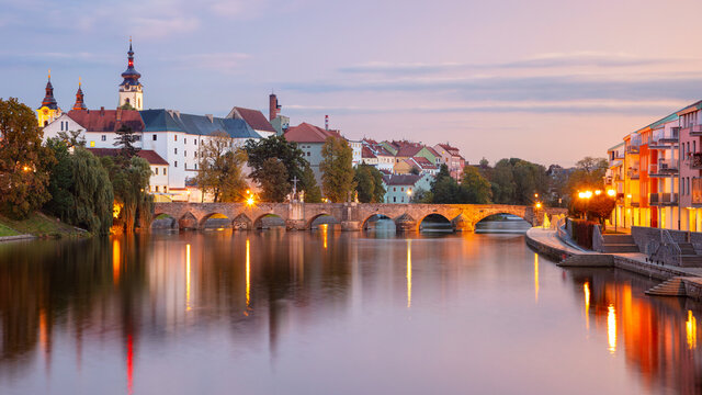 Pisek, Czech Republic. Panoramic cityscape image of Pisek with famous Stone Bridge at beautiful autumn sunset.