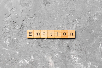 emotion word written on wood block. emotion text on table, concept