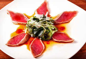 Japanese Tuna Tataki appetizer in a white plate