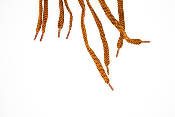 Brown shoelaces on white background