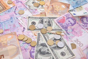 collection of dollar and hryvnia with euro banknotes and coins, close view