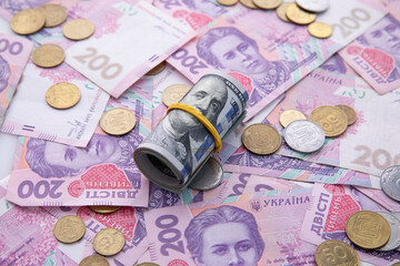 collection of dollar and hryvnia banknotes with coins , close view