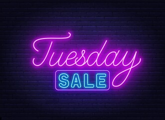 Tuesday Sale neon sign on brick wall background .