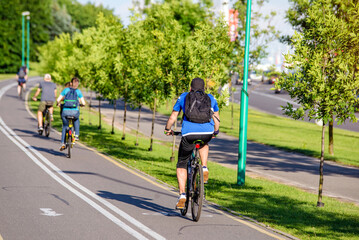 Cyclists ride on the bike path in the city Park
