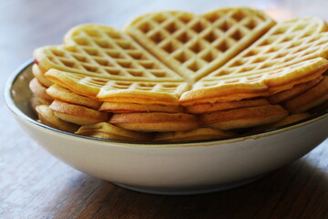 A stack of heart shape pancakes vaffles on plate