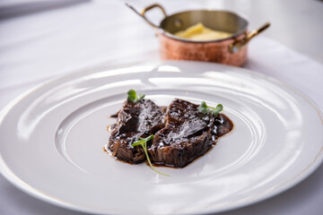 Beefsteak specialty prepared in olive oil with mashed potatoes