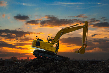 Excavators are digging the soil in the construction site on the  sunset  background