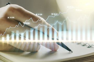 Double exposure of abstract creative financial diagram with hand writing in notebook on background,...