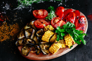 Fototapeta na wymiar Grilled vegetables. Corn, tomatoes, mushrooms