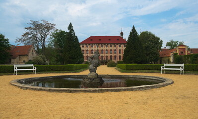 Libochovice Chateau (Zamek Libochovice). Fountain view from a park surrounding the chateau located in the town of Libochovice in the Central Bohemian Uplands, Czech Republic.