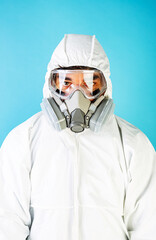 Fototapeta na wymiar Man wearing protection face mask, glasses and clothing against coronavirus. Isolated on blue background.