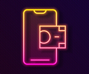 Glowing neon line Mobile banking icon isolated on black background. Transfer money through mobile banking on the mobile phone screen. Vector.