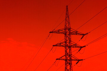 High voltage tower lines on a red background
