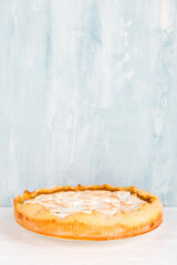 Pear pie with cream, homemade delicious pastries, dessert for breakfast, on a white table. Copy space.