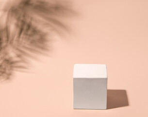 White empty podium in cube shape on beige background