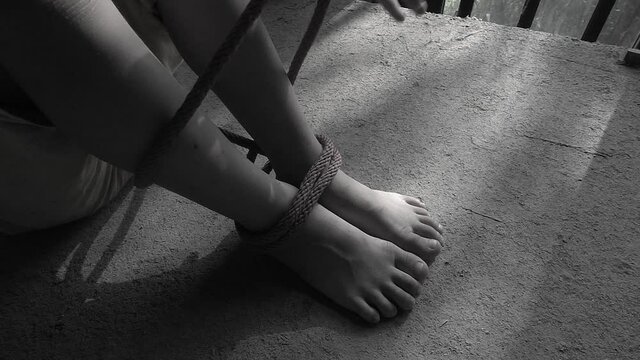 Children bound by ropes, violence against children concept.