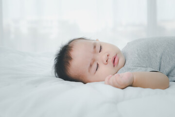 Fototapeta na wymiar Asian little baby girl sleeping on bed.
