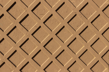 Naklejka premium The surface of a concrete fence with a diamond-shaped relief.