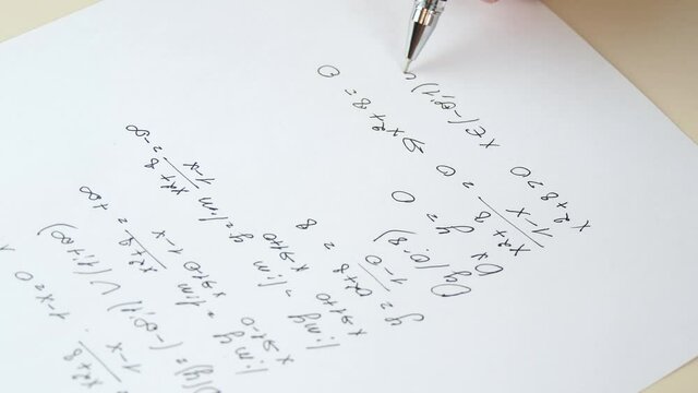 Calculation of mathematical formulas. A close-up hand writes an algebraic formula on a white sheet of paper. Distance learning.