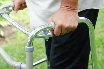 Elderly people catch walkers Help walk due to an inflamed knee. Concept of health care
