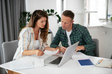 Husband and wife preparing bills to pay. Young couple having financial problems