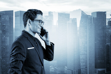 Prosperous handsome entrepreneur in suit and glasses pensively talking phone and looking on Singapore cityscape. The concept of problem solving consulting . Downtown view. Double exposure.