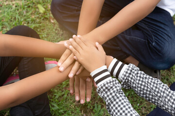 Children hand stack and hold together in team for success something or take care.