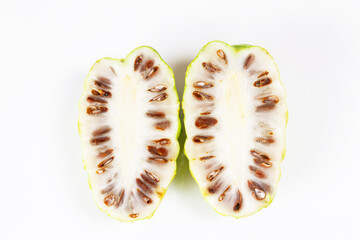 Fresh Noni fruit sliced or Morinda Citrifolia isolated on white background. Noni high nutrients and antioxidants.