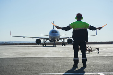 The runway traffic controller uses gestures and sticks to help the aircraft choose the correct...