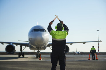 The runway traffic controller uses gestures and sticks to help the aircraft choose the correct...