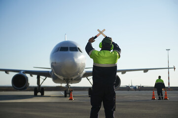 The runway traffic controller uses gestures and sticks to help the aircraft choose the correct...