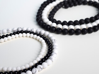 Black and white beads from natural semi-precious stones on a white background
