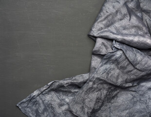black kitchen textile towel folded on a black wooden table